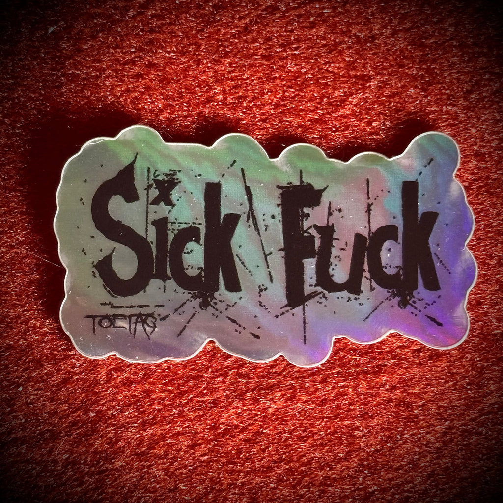 A die-cut sticker with the words 'Sick Fuck' in black distressed lettering over an holographic background.