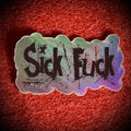 A die-cut sticker with the words 'Sick Fuck' in black distressed lettering over an holographic background.
